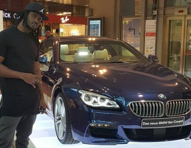 Bebe Cool pauses next to car