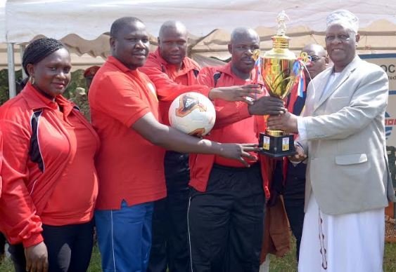 L- R Aminah Bukenya, David Byaruhanga, Ronald Kaija and Zakaria Lubega the representatives from CNOOC handover a cup, balls, medals, jerseys among other football items to the King of Bunyoro Kitara Kingdom Dr. Solomon Gafabusa Iguru in Kagadi District