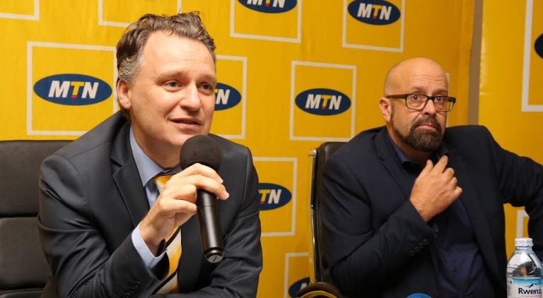 MTN Uganda CEO Wim Vanhelleputte (left) addresses the media at the MTN CEO Briefing held at MTN Towers on Tuesday. He is flanked on the right by Olivier Prentout (Chief Marketing Officer).