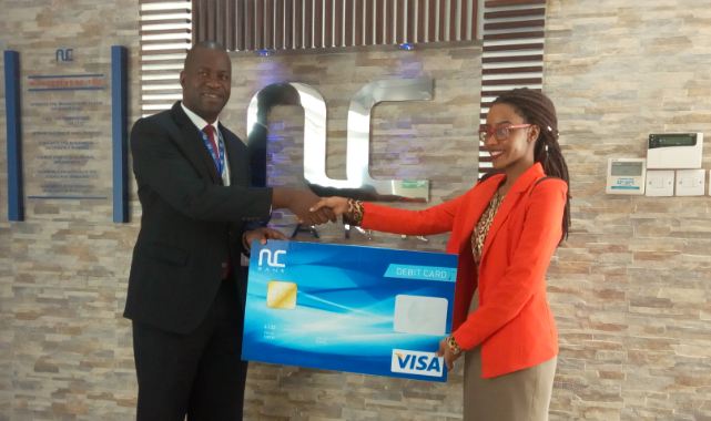 Jenna Kirabo is the first customer to receive the Visa debit card.