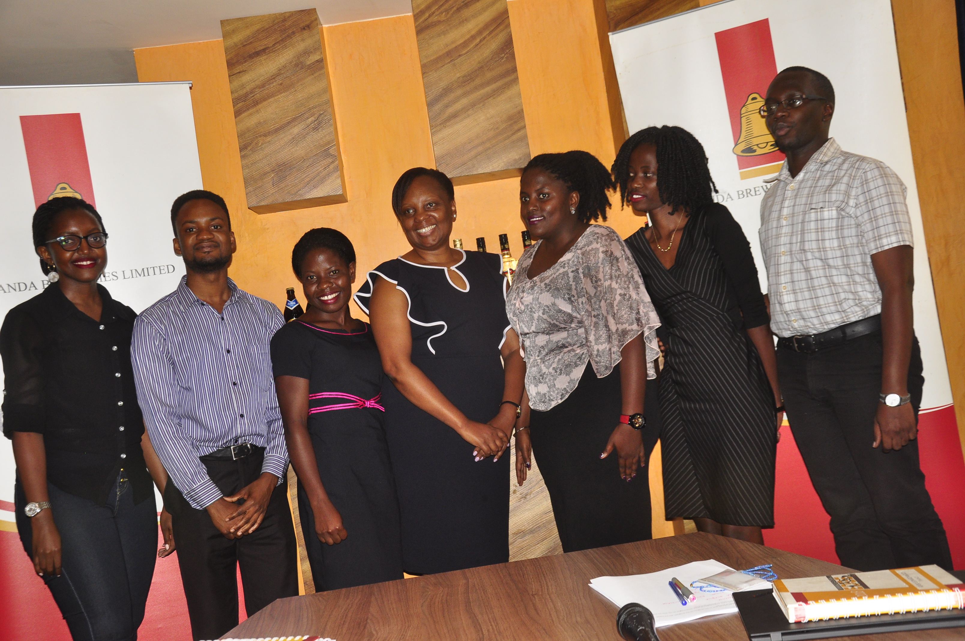 Uganda Breweries Human Resources Director Catherine Khabure(Centre) with the 2019 UBL graduate trainees Dorah Kukunda, Collin Kajubi , Patience Katulinde Brenda Kobutungi, Fridah Nakibuuka and Simon Patrick Lapyem.