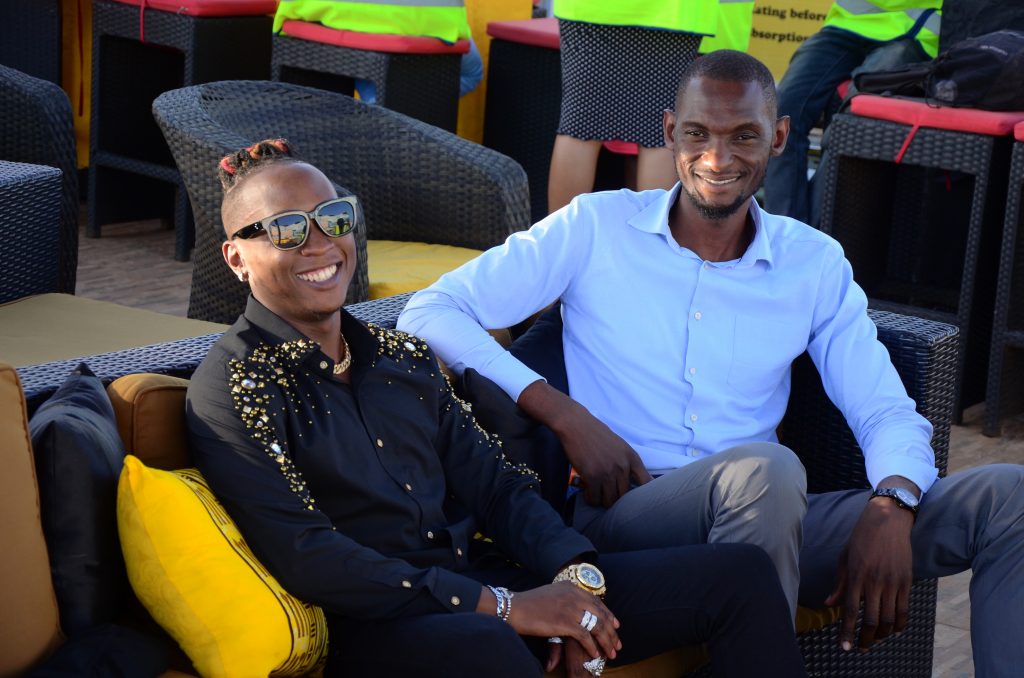 Beenie Gunter poses with Bell Lager Brand Manager Francis Kirabira.