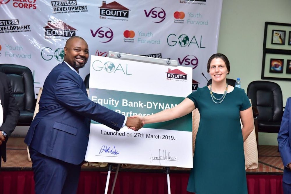 Equity Bank Uganda Executive Director Mr Anthony Kituuka and Jennifer Williams Country Director GOAL sign a plaque at Imperial Royale Hotel in Kampala to launch the Equity Bank DYNAMIC partnership.