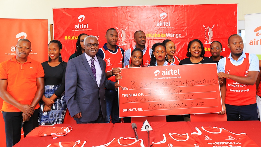 Airtel staff members hand over their contribution towards the Kabaka Run.