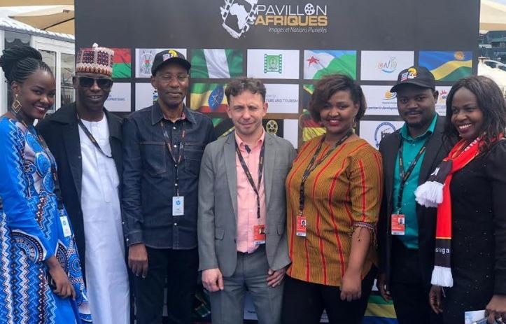 Uganda team at Cannes poses for a group photo after a panel discussion on Uganda's film industry at the African Pavilion in Cannes, France.