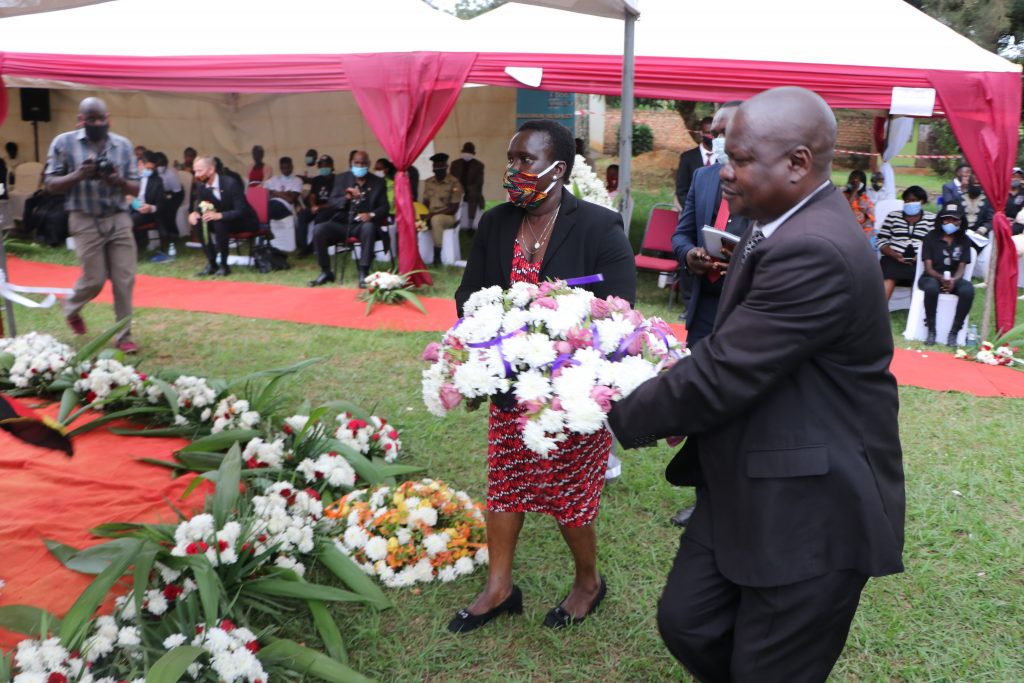 The Director Criminal Investigation, AIGP Grace Akullo lays a wreath on late Esther Nakajjigo's casket during the memorial service.